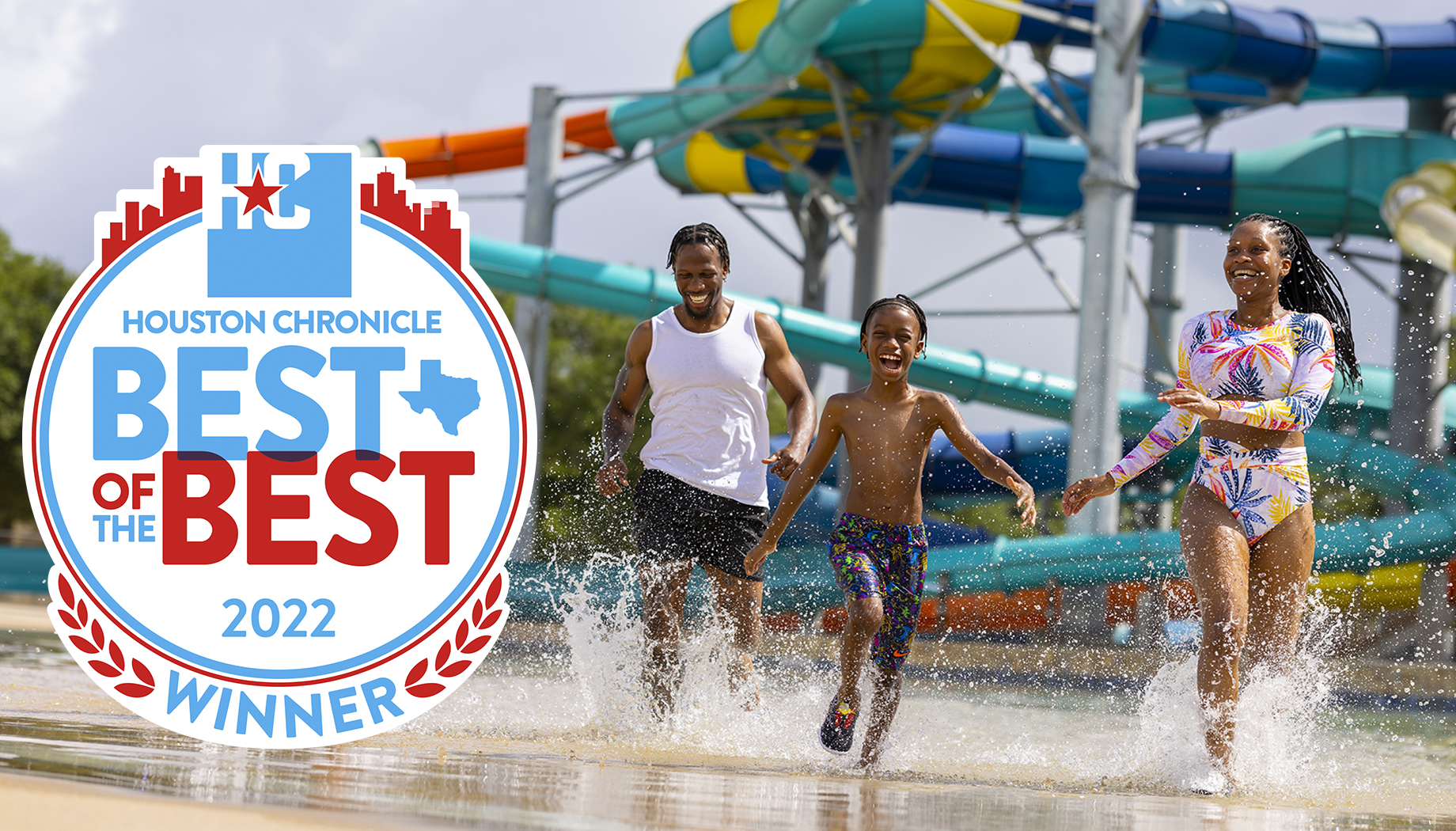 BLOG A family of three runs through water at a waterpark. The image includes a Houston Chronicle "Best of the Best 2022 Winner" badge.